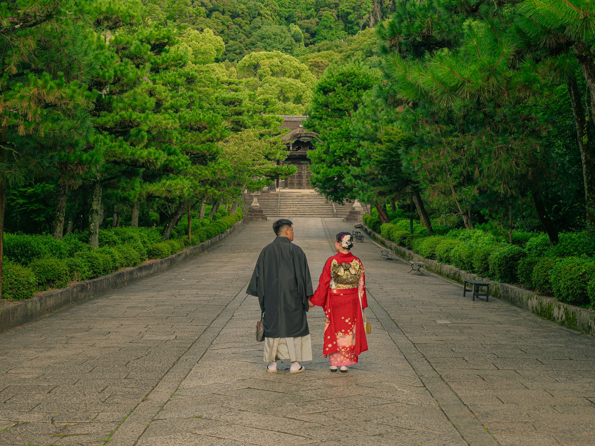 Couple in traditional japanese attire walking up a path